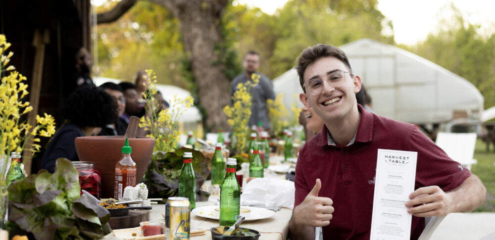 Happy student at farm table dinner